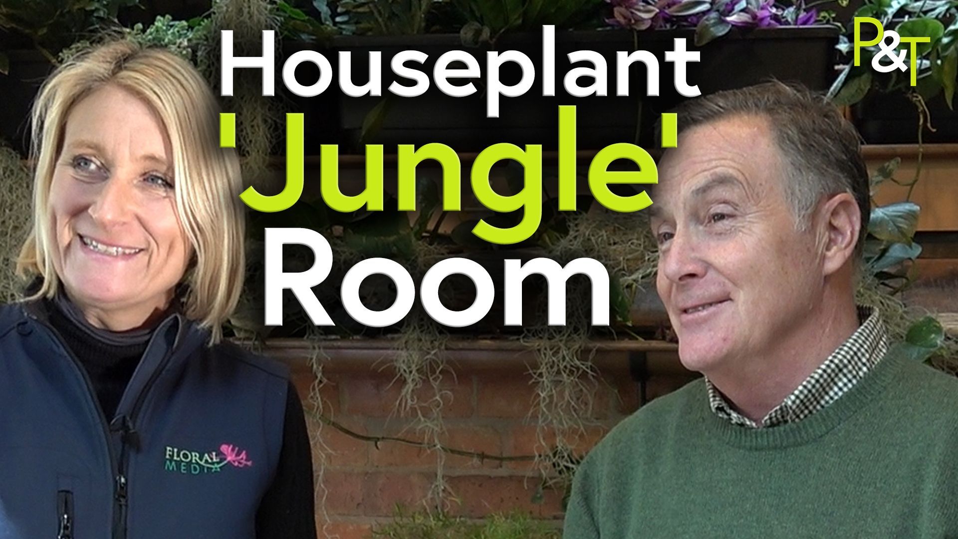 Paula Routledge left of frame and Martin Fish right of frame, both standing in front of a wall where some tropical fronds are hanging. The text Houseplant Jungle Room in green and white over the top of the image.