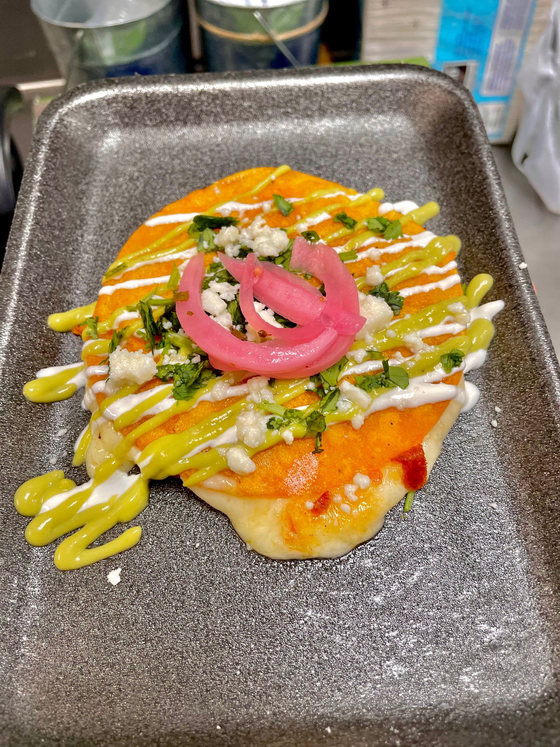 Mulita style quesadilla with avocado salsa, crema, cotija, pickled red onion and salsa