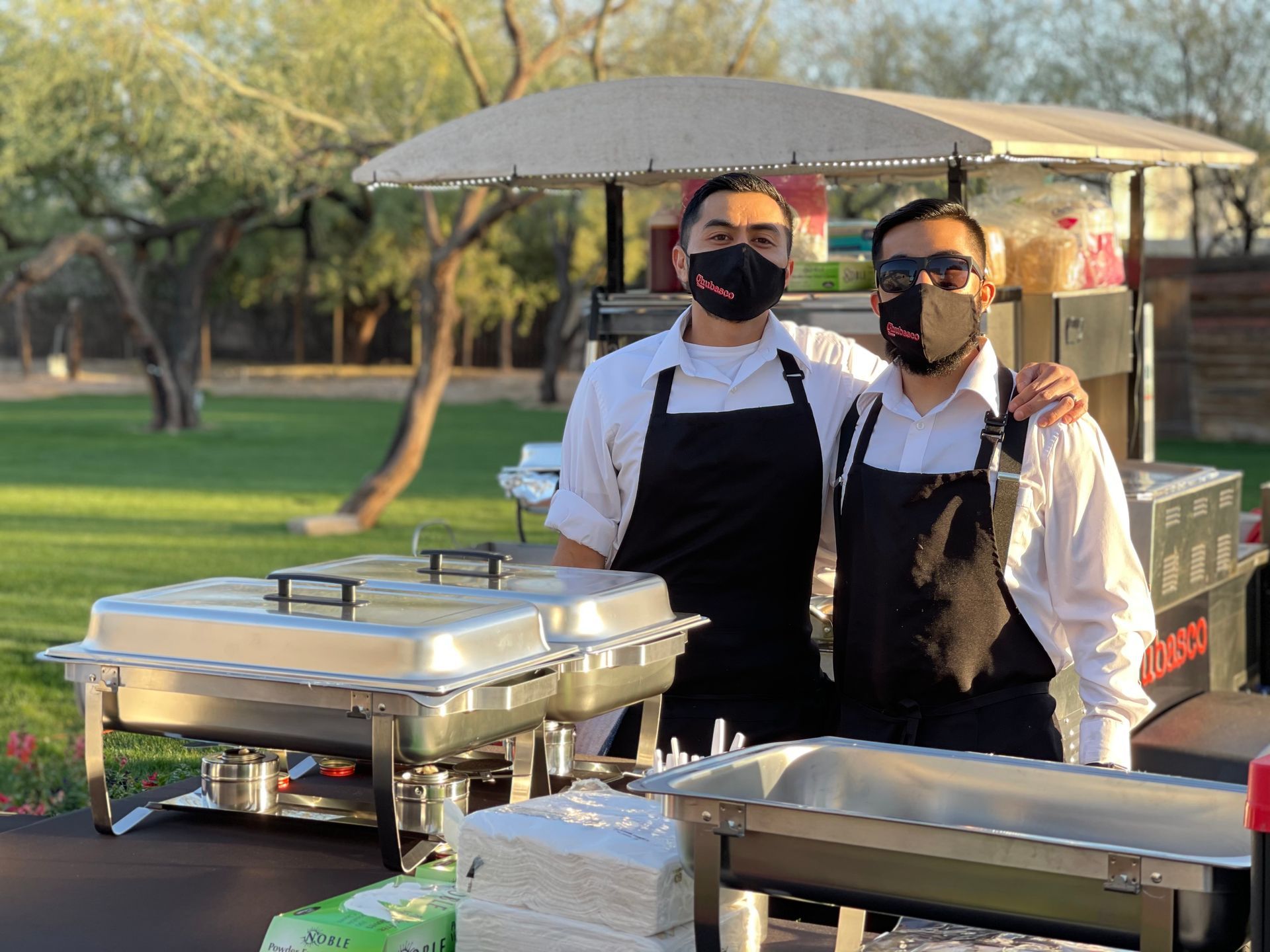 Chubasco Tacos chefs serving Sonoran-style tacos and hot dogs at Phoenix catering event