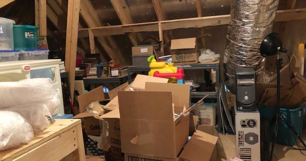 An attic filled with lots of boxes and toys.
