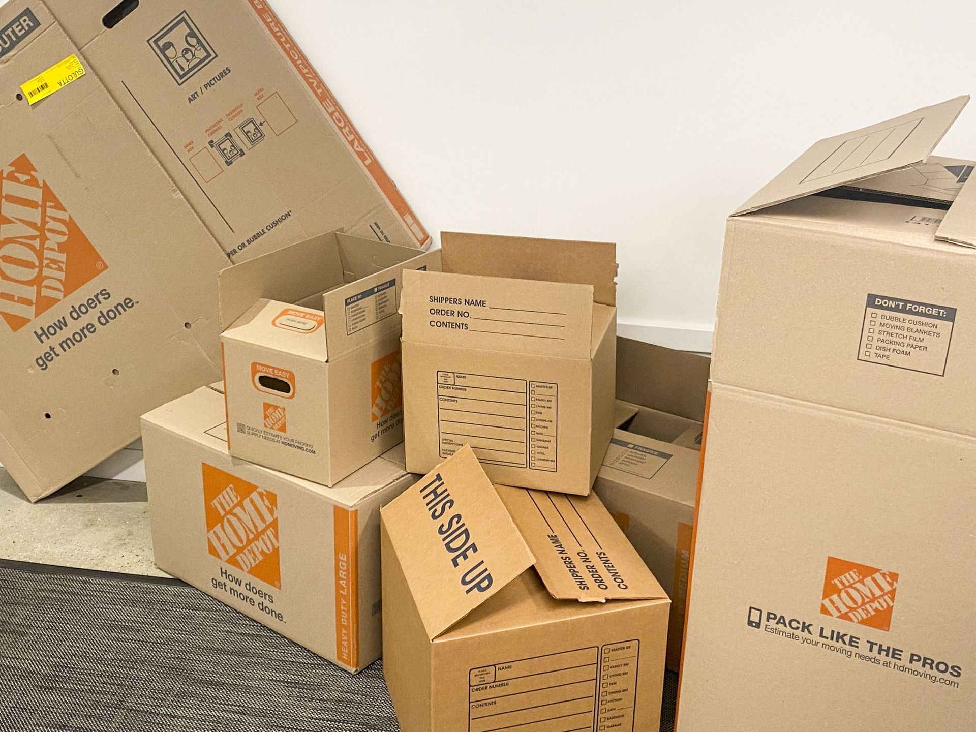 A bunch of home depot boxes are stacked on top of each other