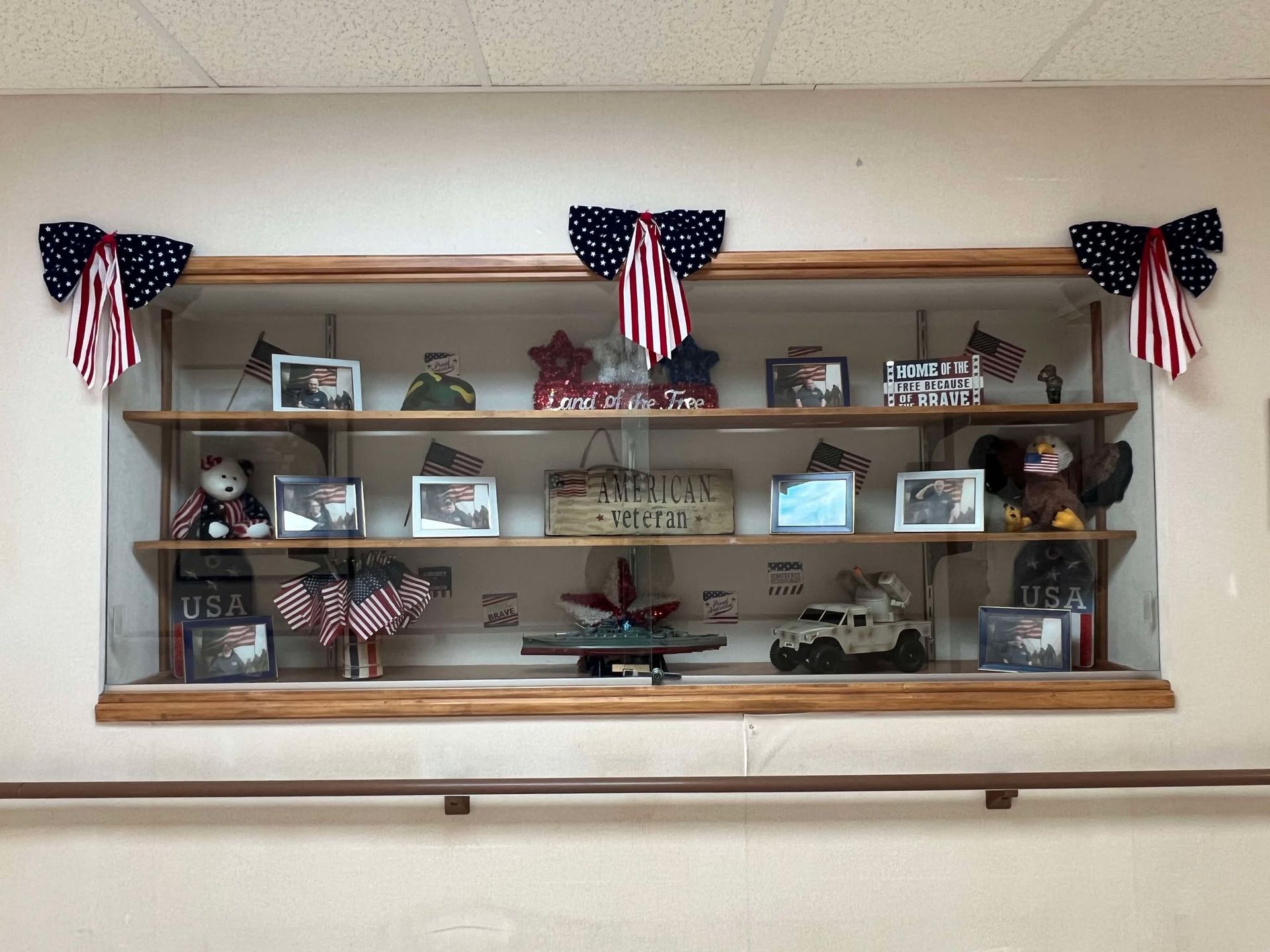 A display case with pictures and flags on it