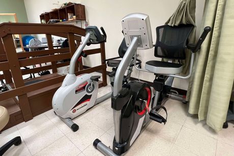 Two exercise bikes are sitting next to each other in a room.