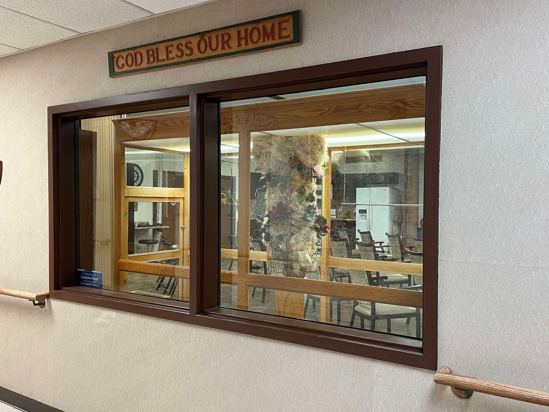 A sign on the wall says god bless our home