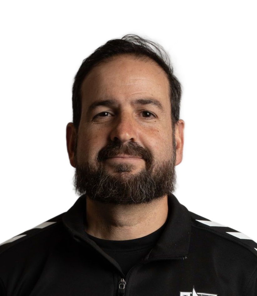 Man with dark hair and beard in a black jacket; neutral expression.