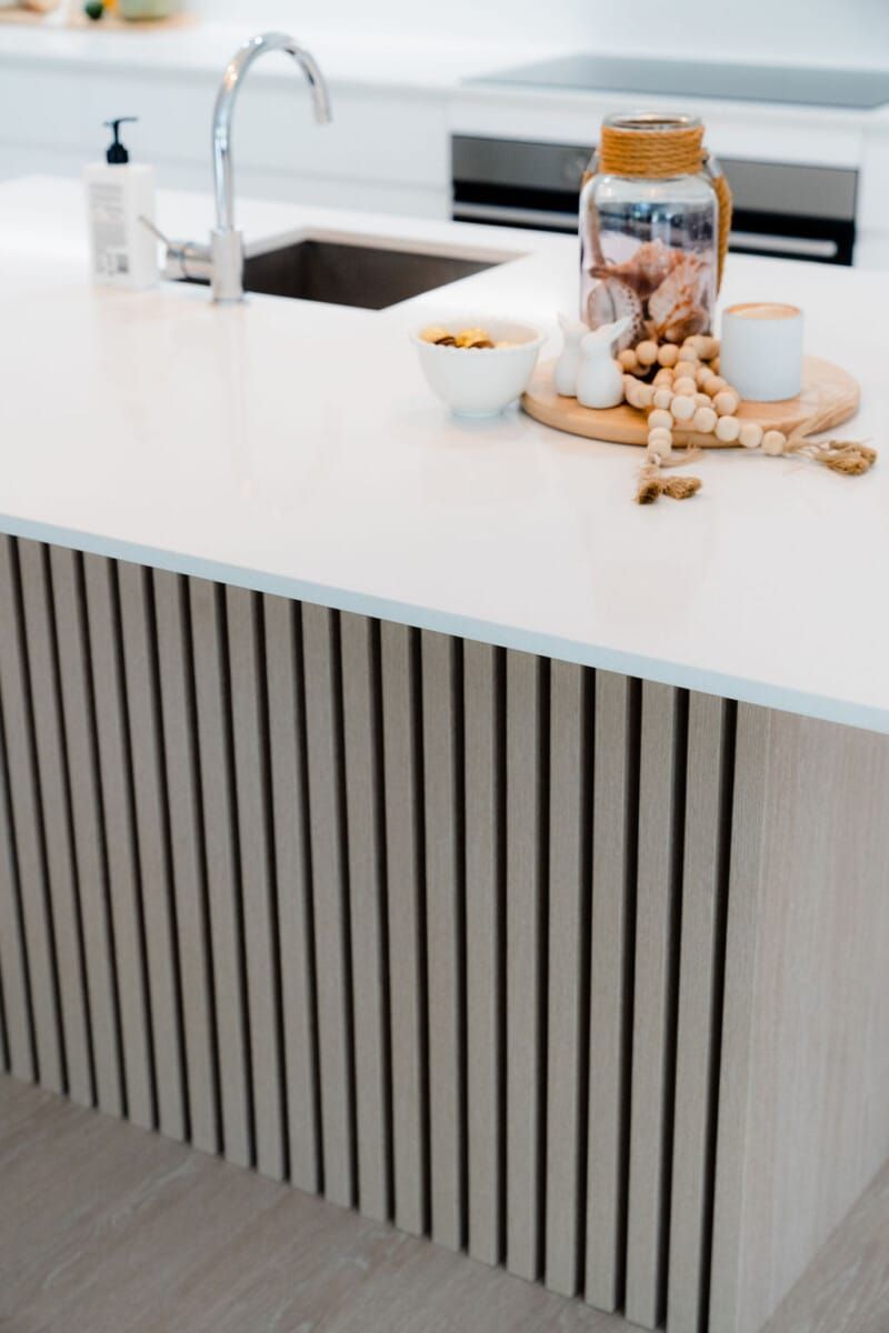 A Kitchen Counter With a Sink and a Jar of Cookies on It — CK Cabinetry in Coolum Beach, QLD