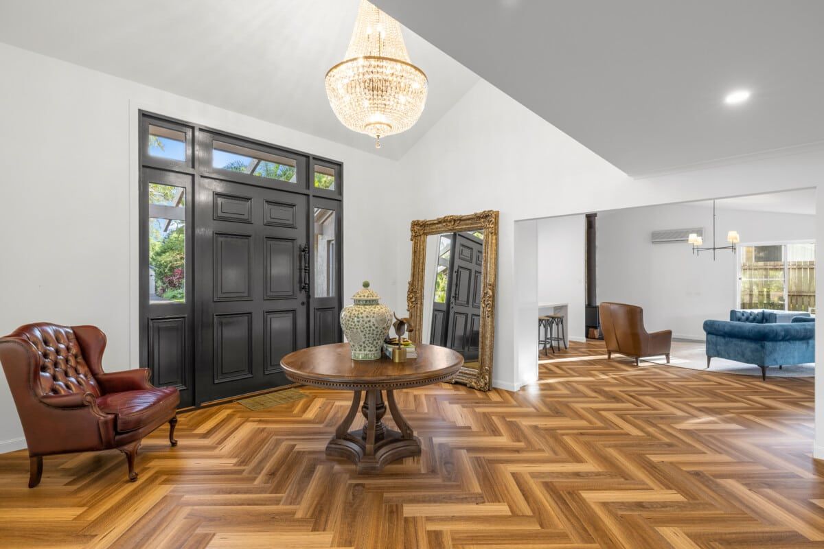 A Living Room With a Round Table, Chairs, and a Mirror — CK Cabinetry in Coolum Beach, QLD
