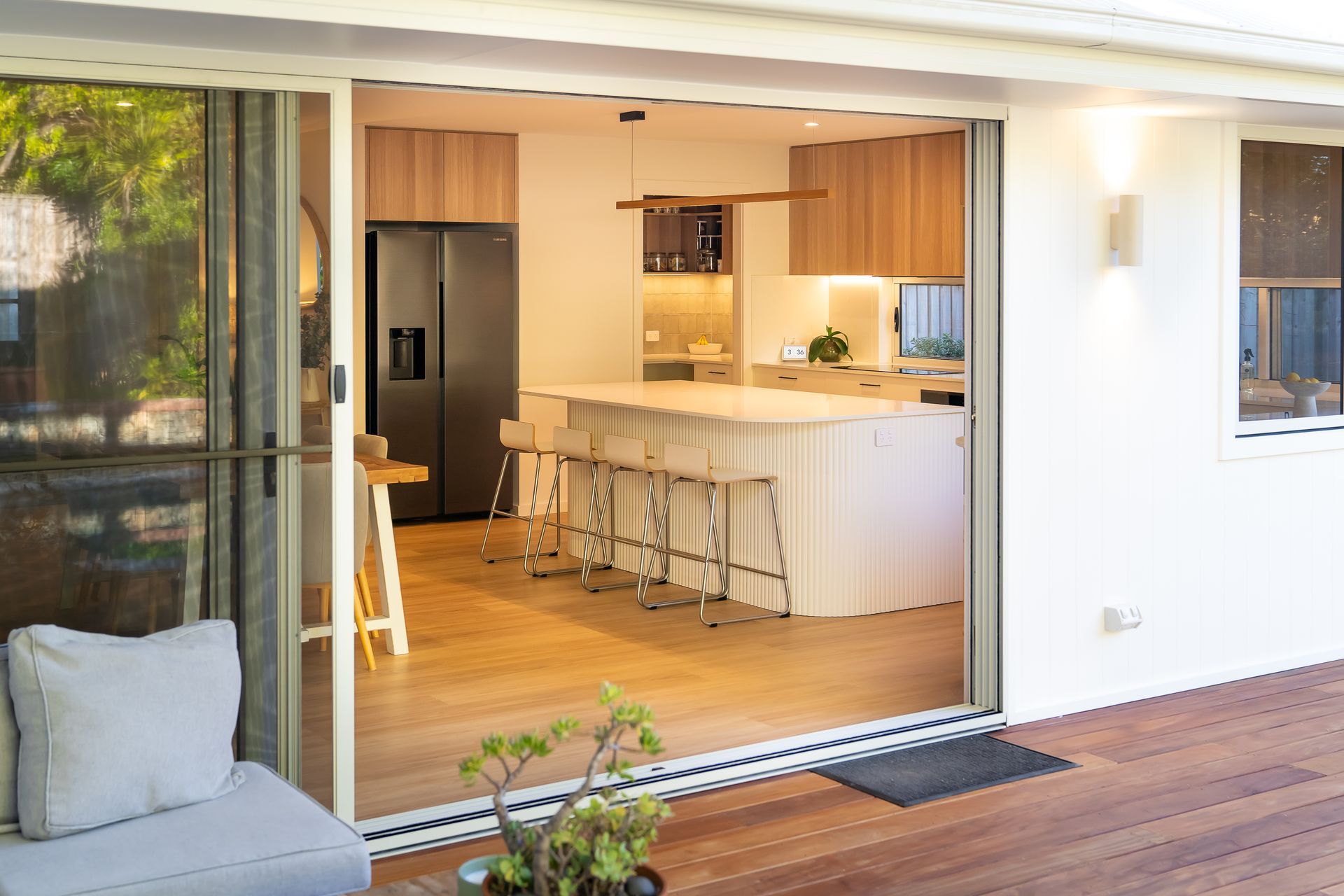 A Kitchen With a Stainless Steel Refrigerator and White Counter Tops — CK Cabinetry in Coolum Beach, QLD