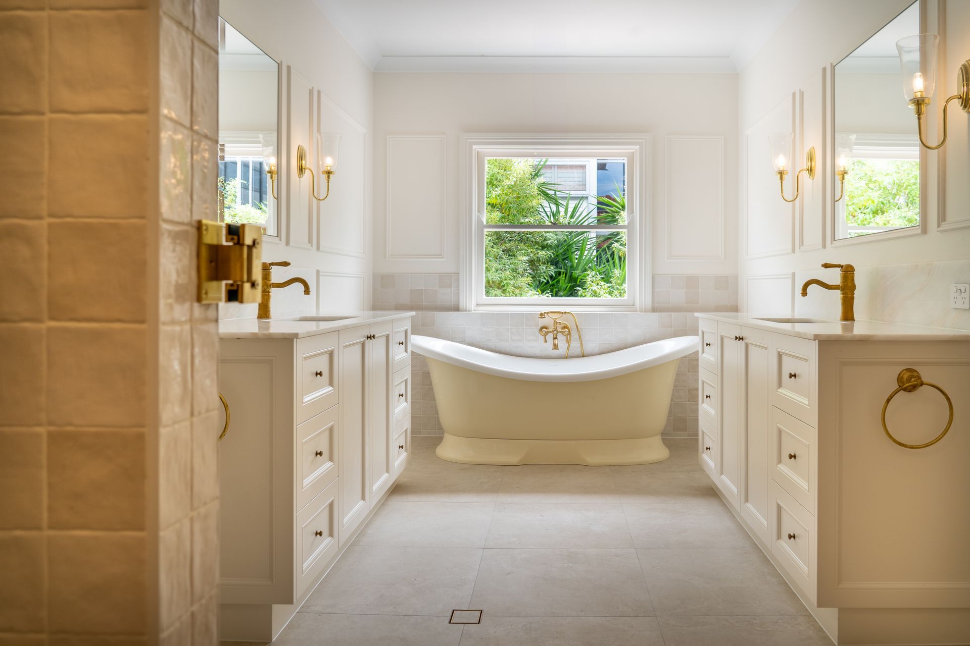 Bathroom with white cabinets, soaking tub, and golden fixtures — CK Cabinetry in Coolum Beach, QLD