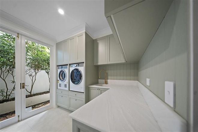 A Laundry Room With a Washing Machine and Dryer — CK Cabinetry in Coolum Beach, QLD