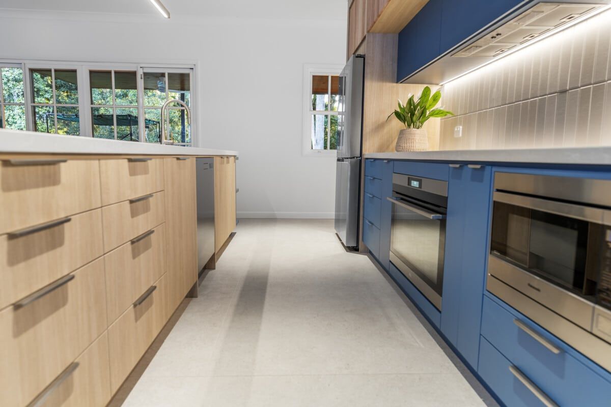 A Kitchen With Blue Cabinets and Stainless Steel Appliances — CK Cabinetry in Coolum Beach, QLD