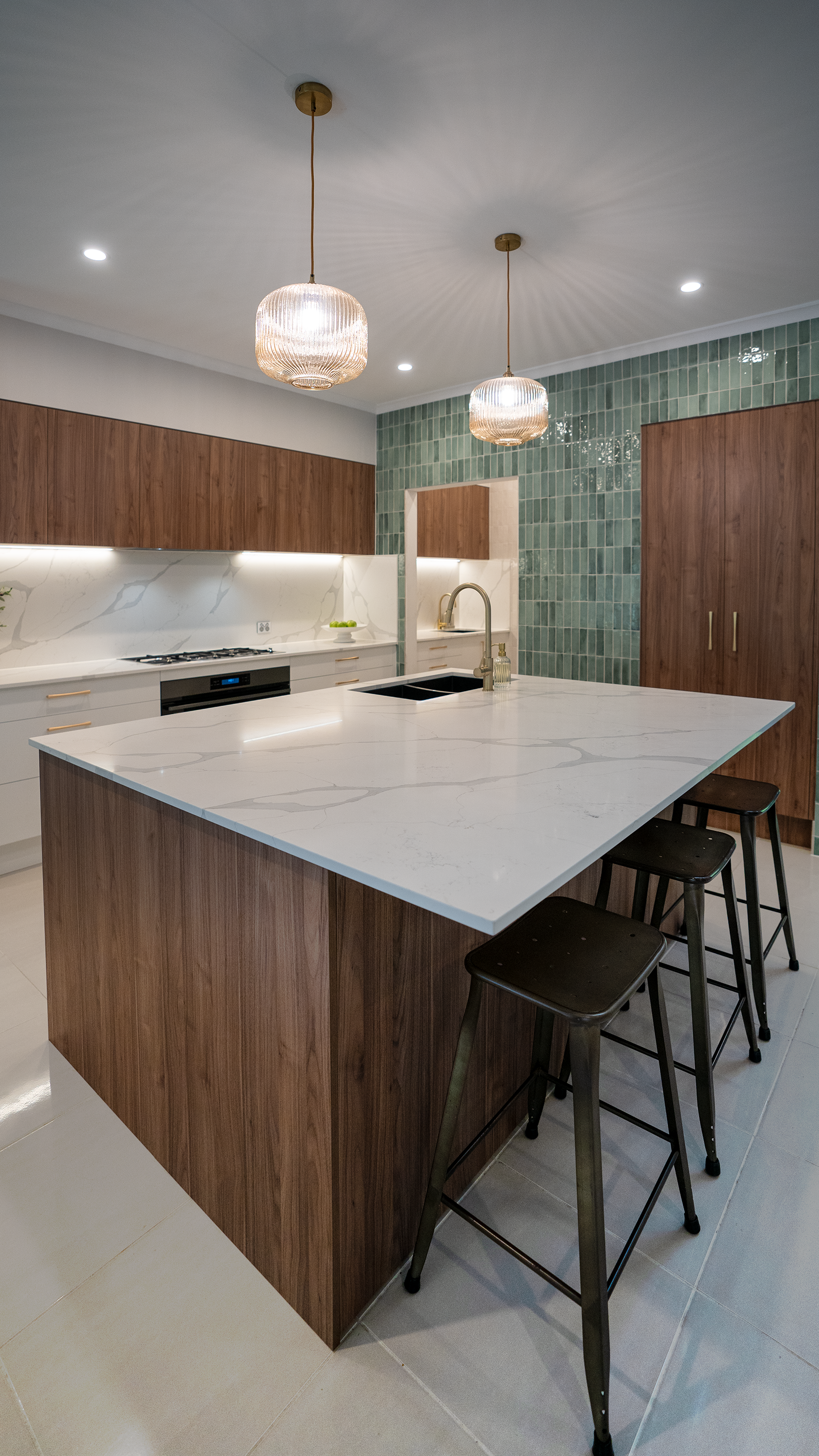 Modern kitchen with a large island and brown wooden cabinetry — CK Cabinetry in Coolum Beach, QLD