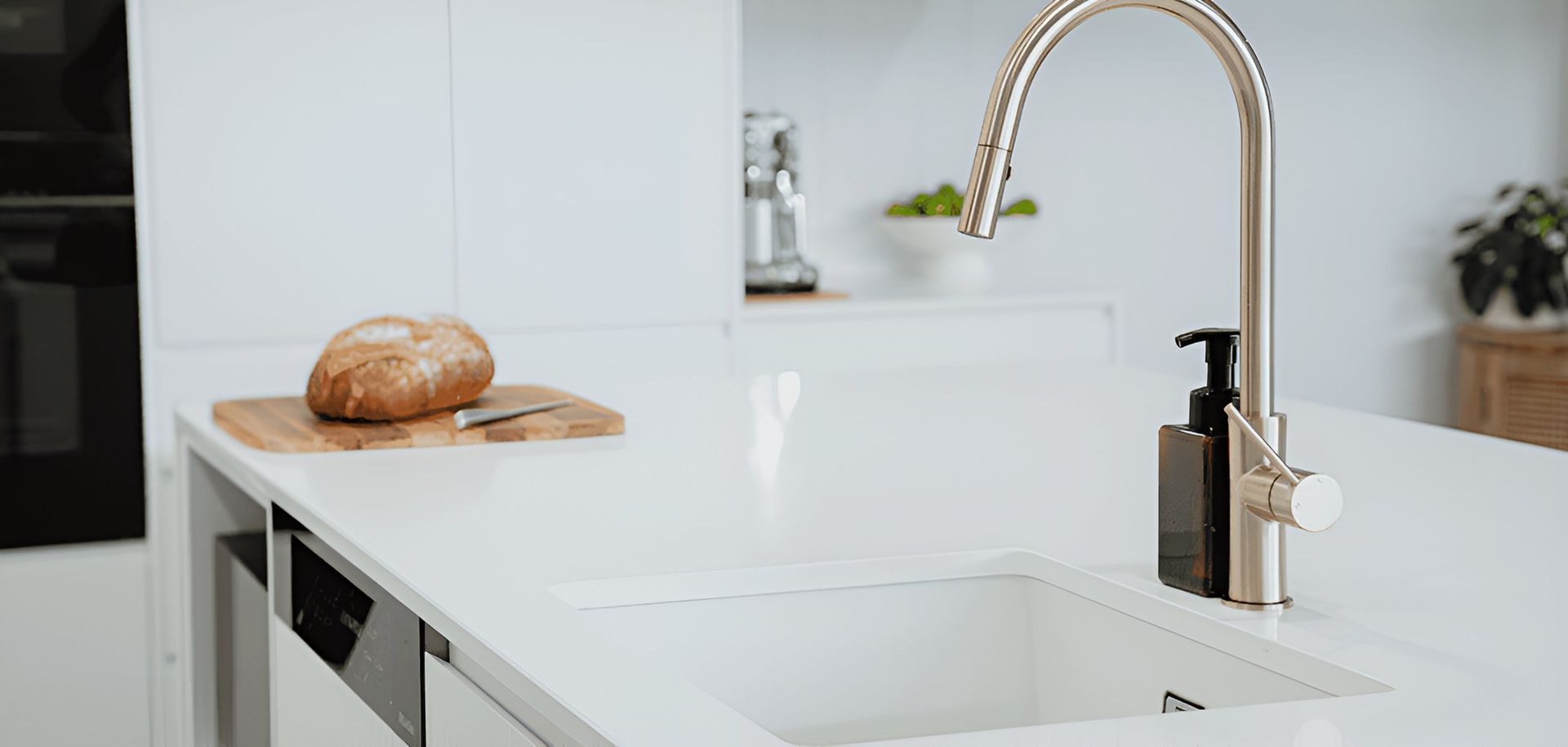 A Kitchen Sink With a Faucet and a Loaf of Bread— CK Cabinetry in Coolum Beach, QLD