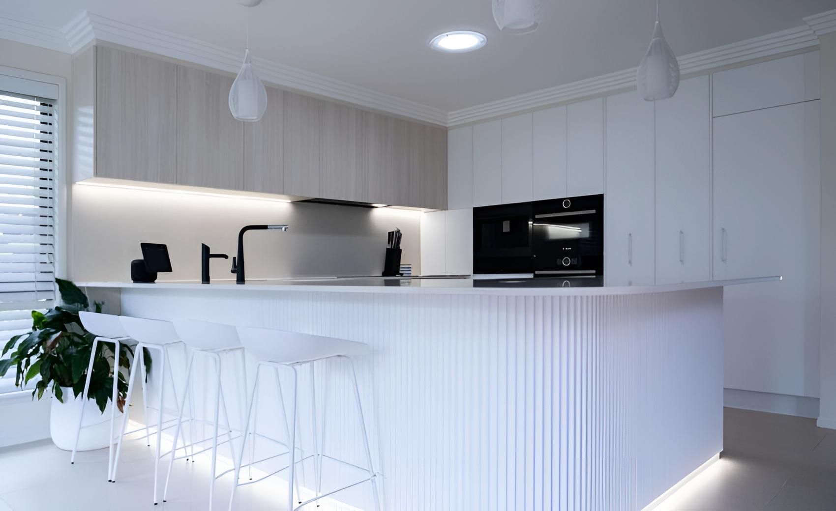 A Kitchen With White Cabinets and Stools and a Large Island — CK Cabinetry in Coolum Beach, QLD
