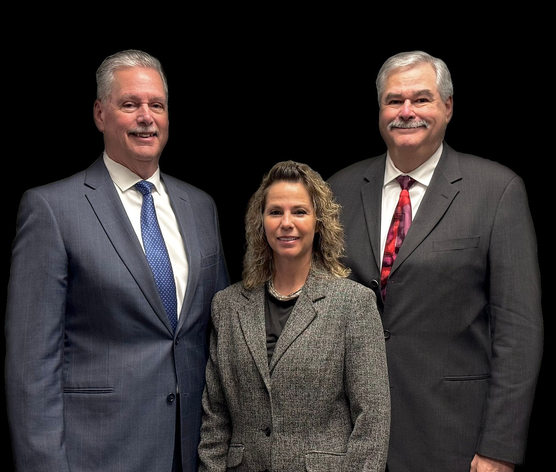 Family of four smiling on a couch in a modern living room.