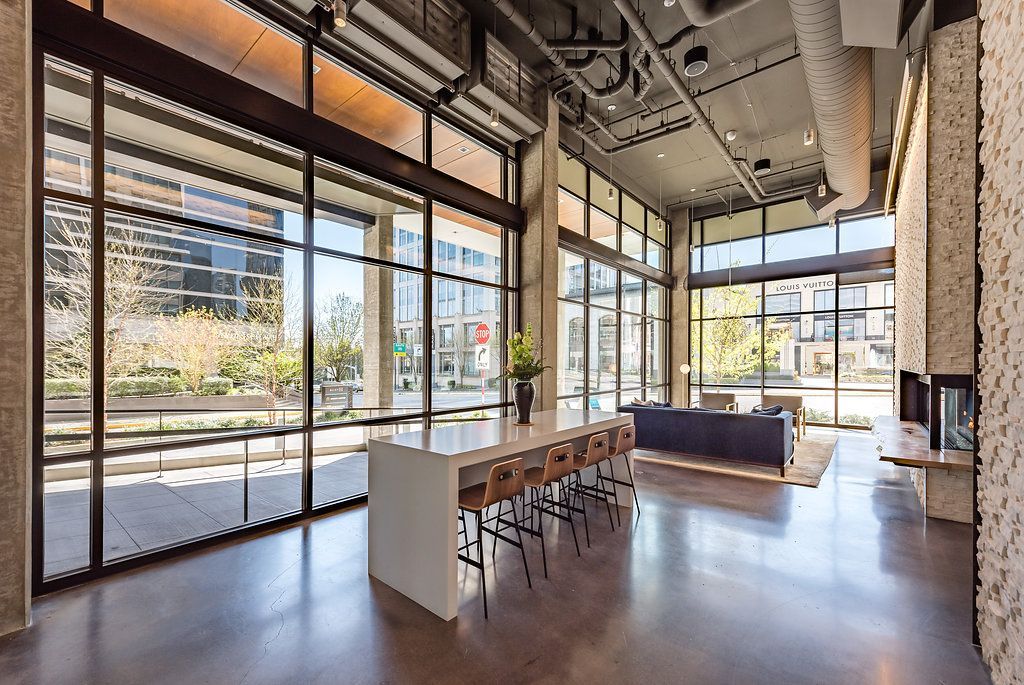 A large clubroom with a table and chairs in it.