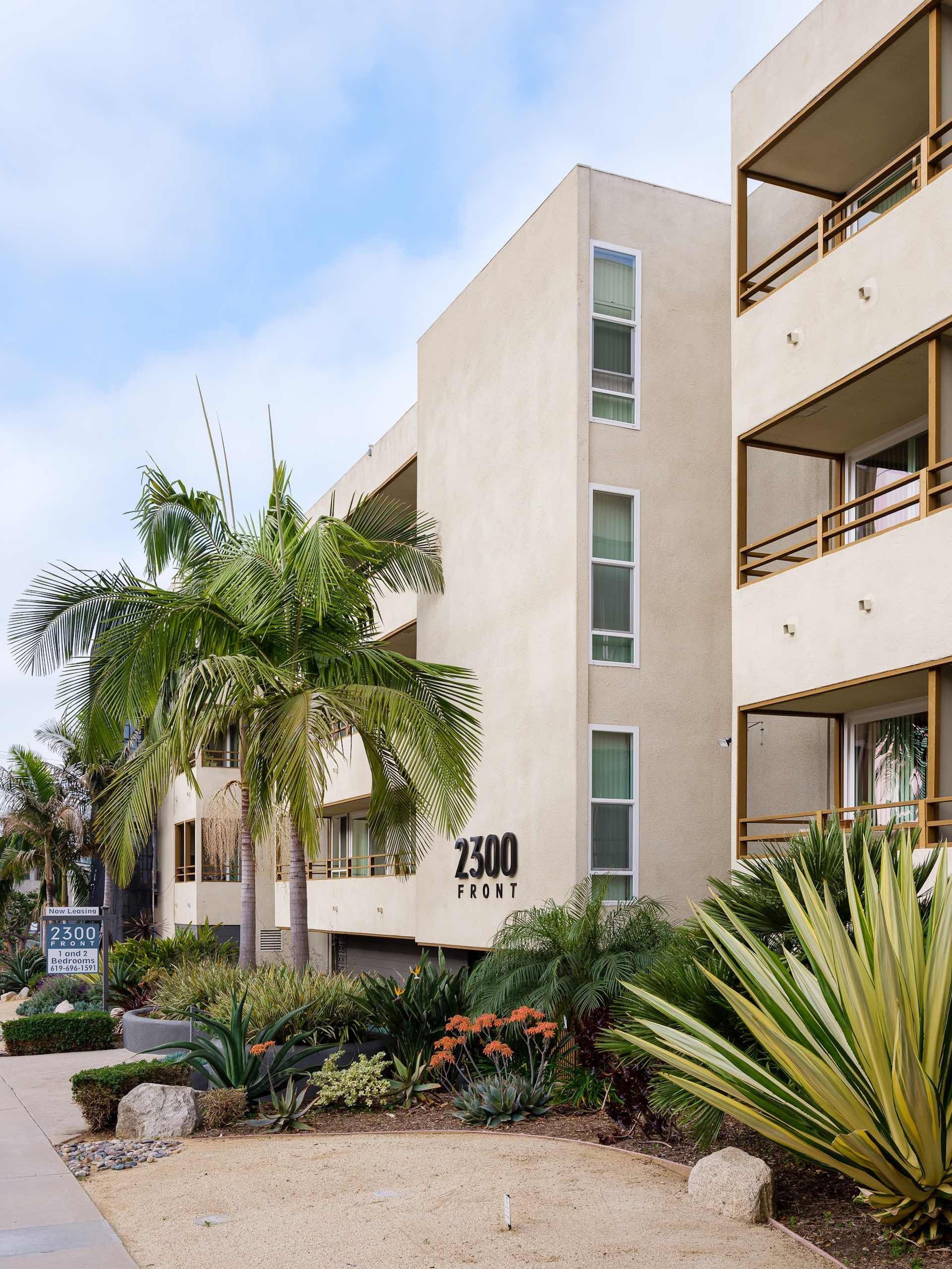 Entryway of apartments lobby with large couches and decor