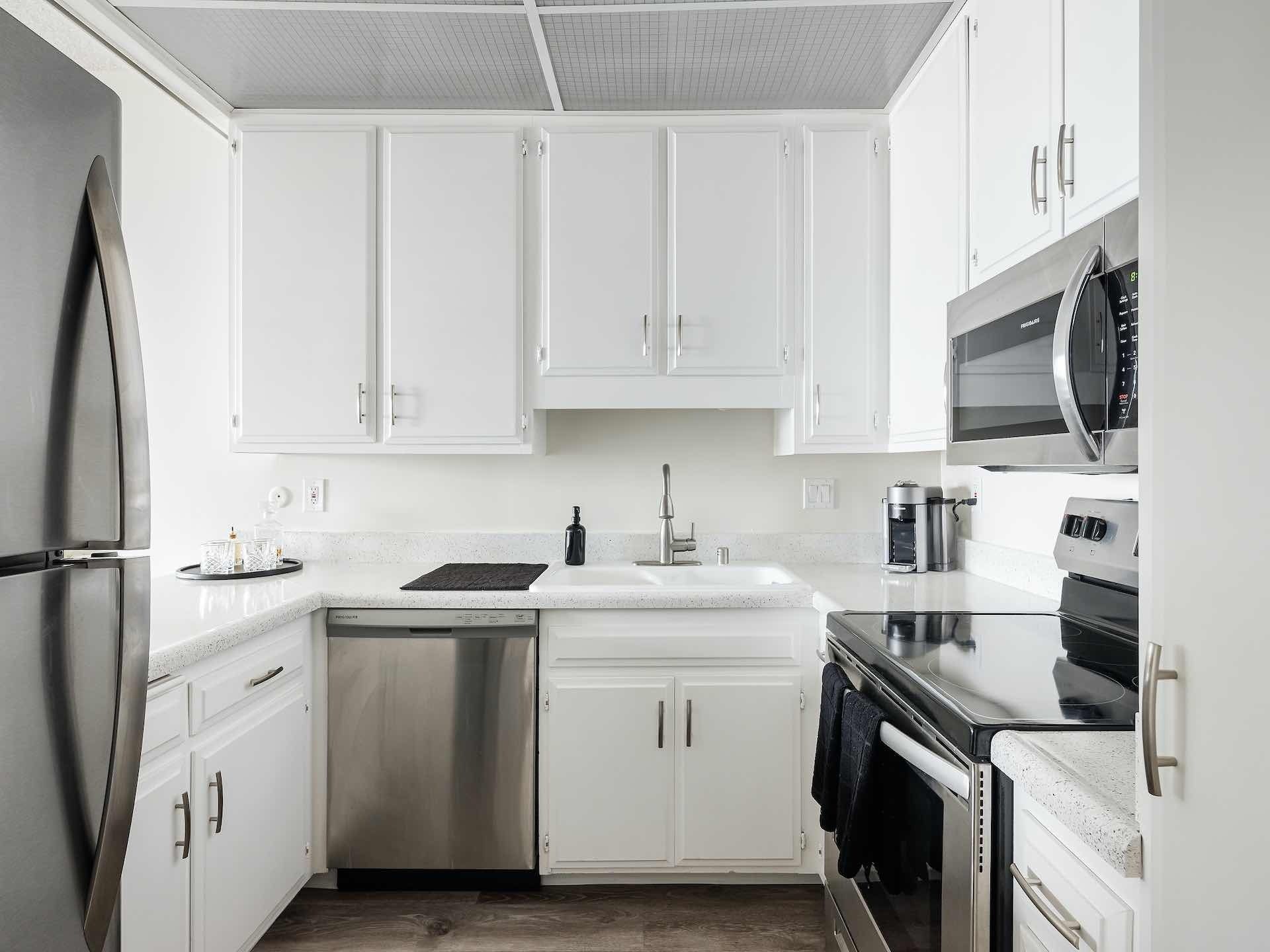 Kitchen with white cabinetry and stainless steel appliances