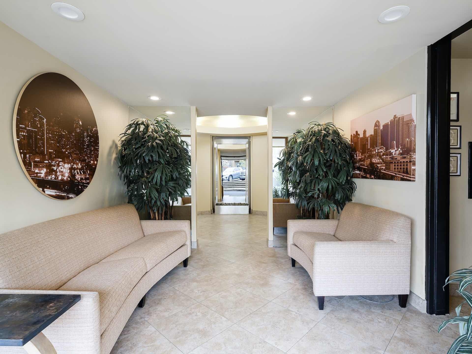 Entryway of apartments lobby with large couches and decor