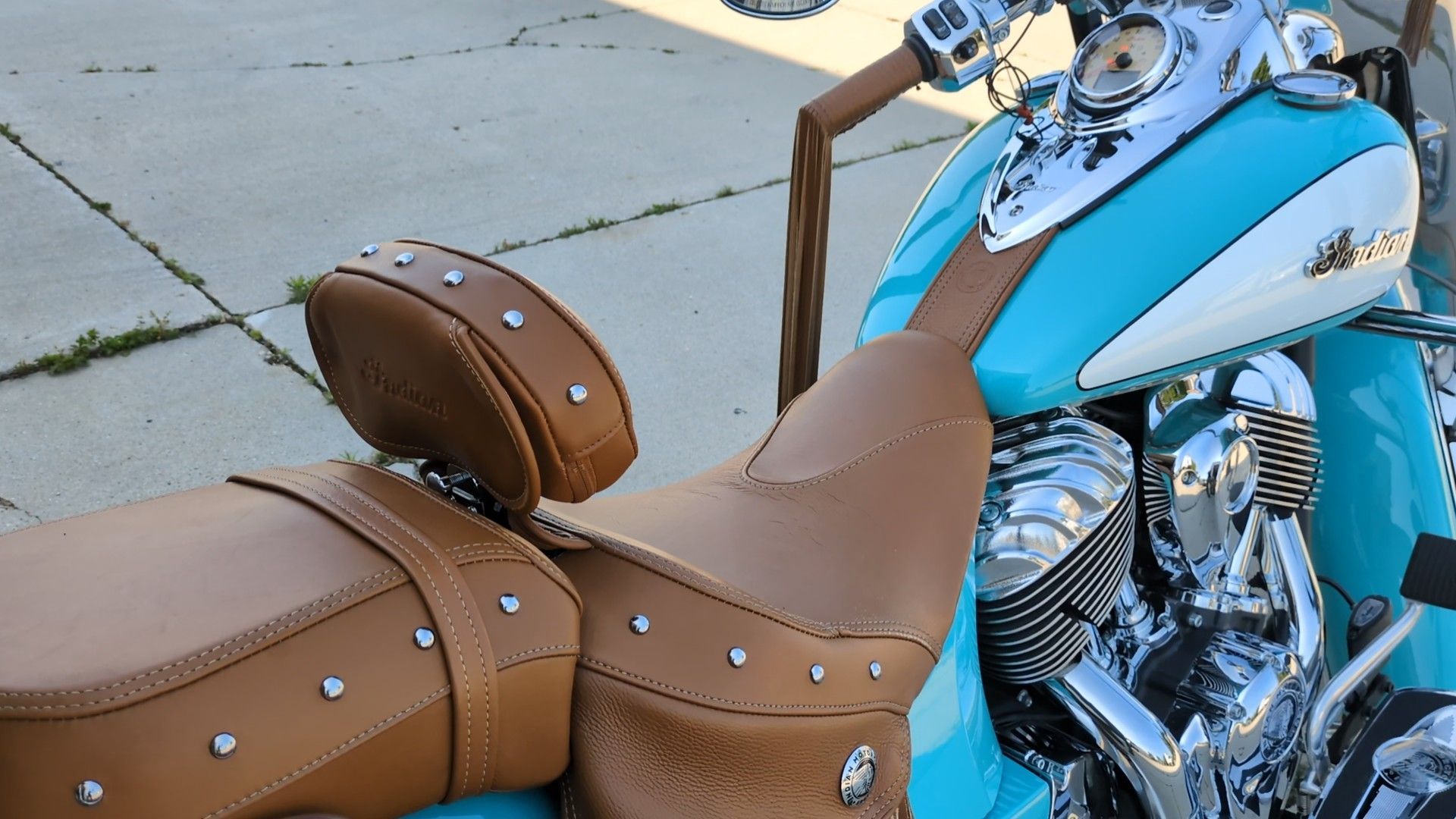 A gray tesla model s is parked in a garage.
