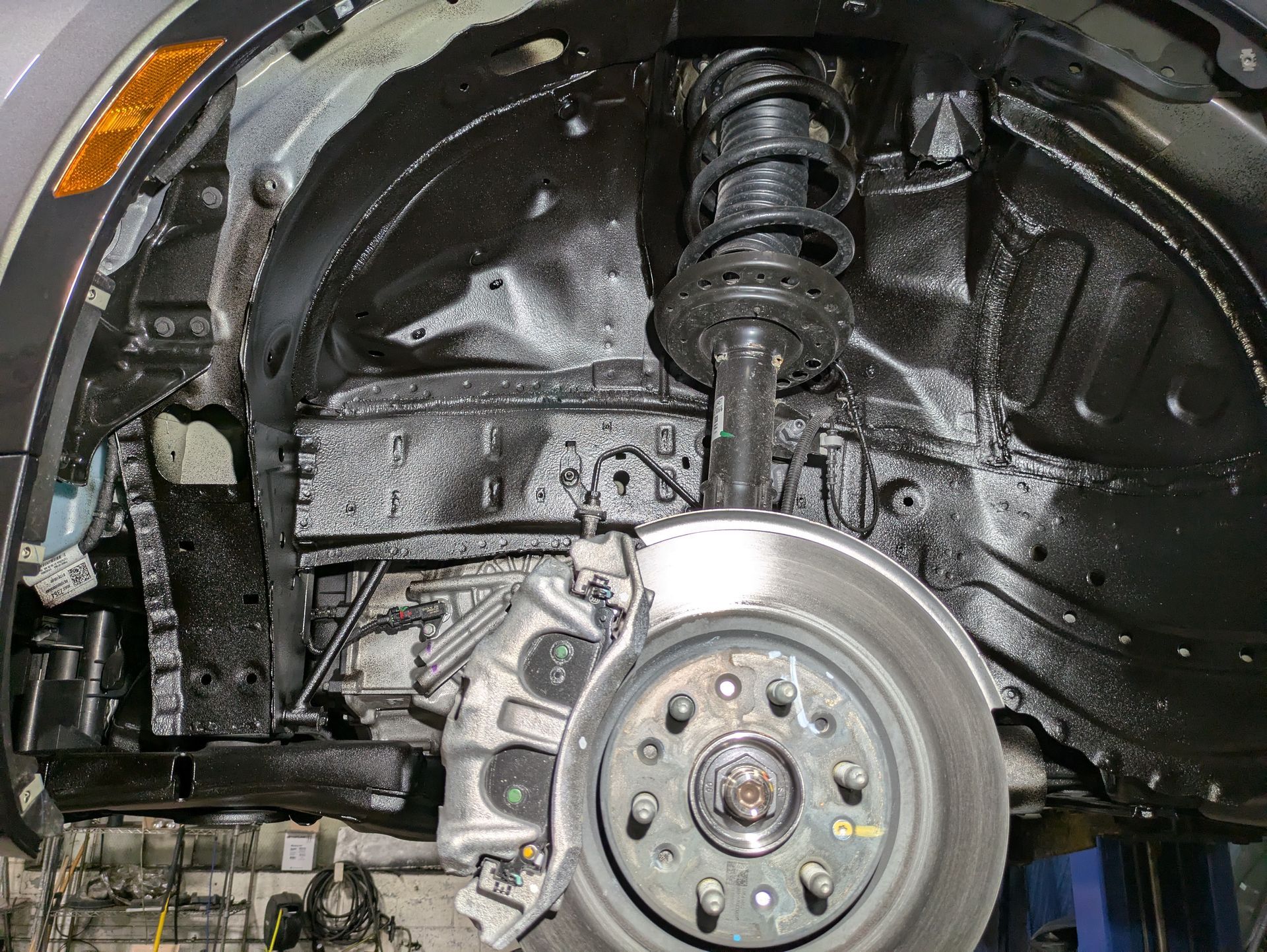 A close up of a car 's suspension and brake system.