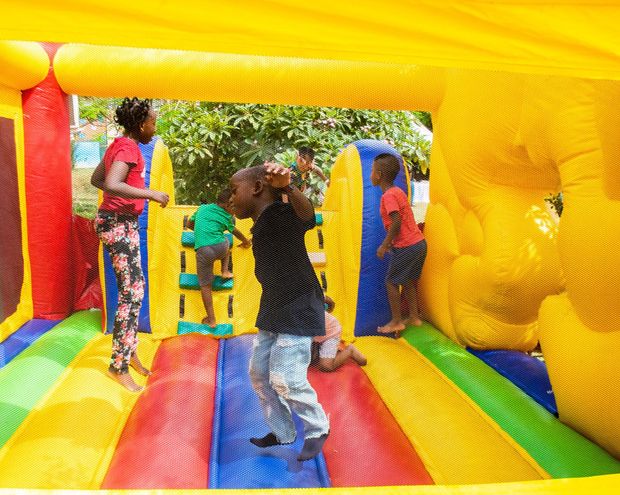 A group of children are playing in an inflatable bouncy house.