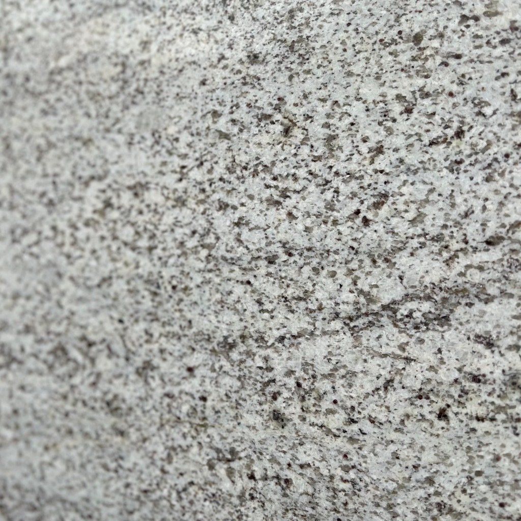 A close up of a white granite counter top.