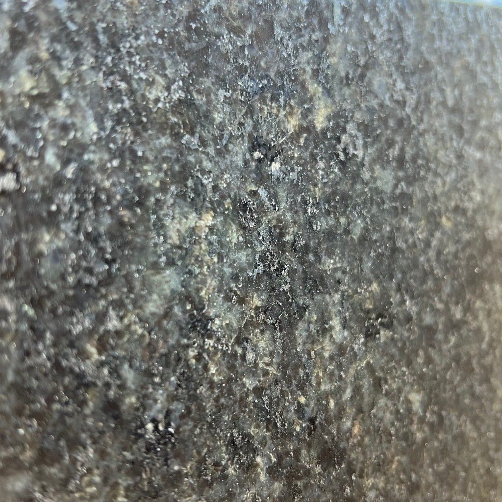 A close up of a black granite counter top