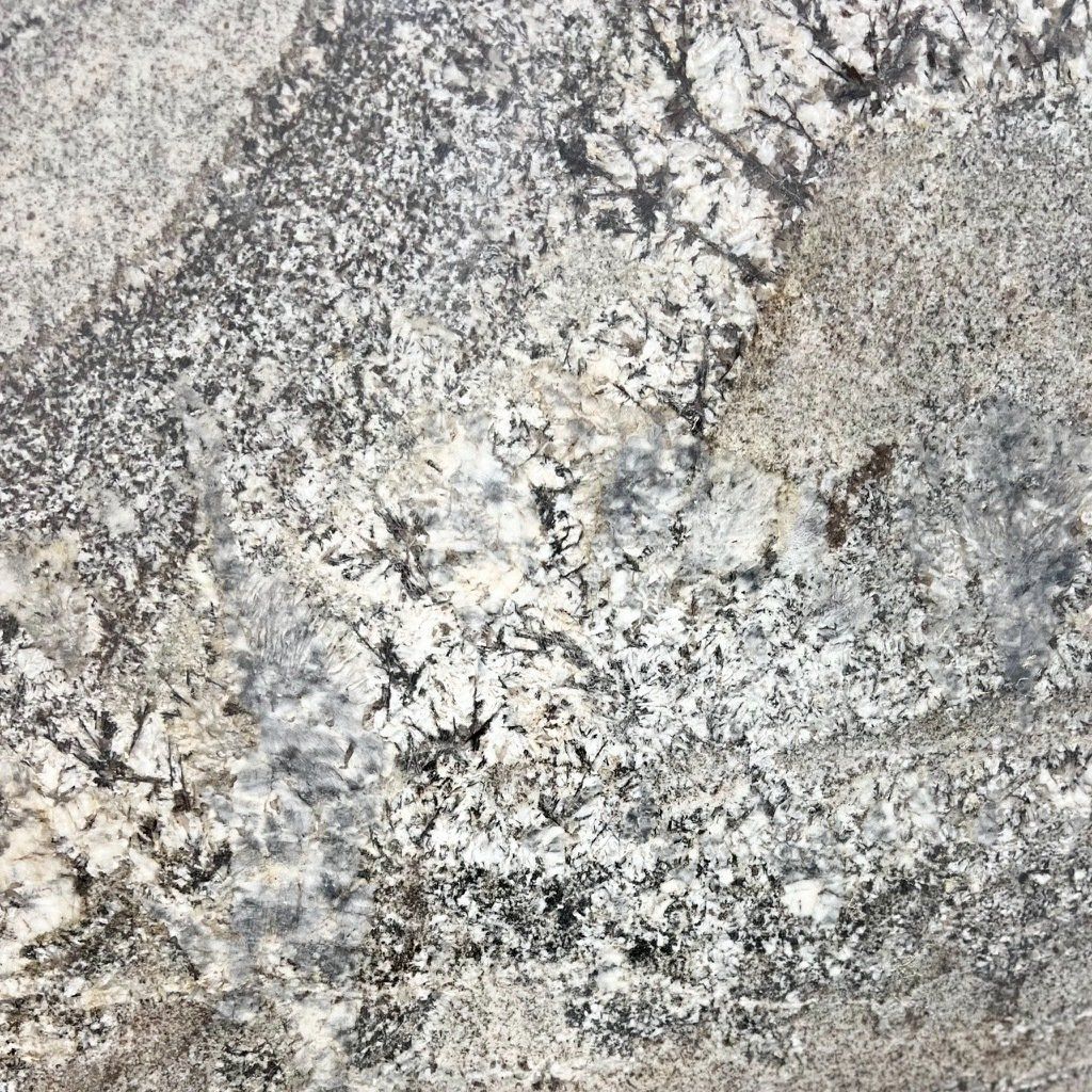 A close up of a granite counter top with a gray and white marble texture.