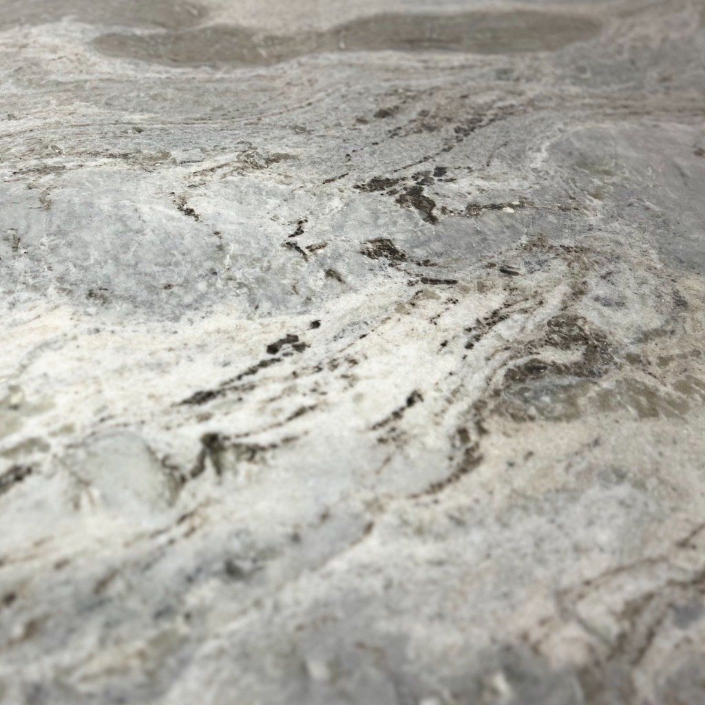 A close up of a marble counter top with a gray and white marble texture.