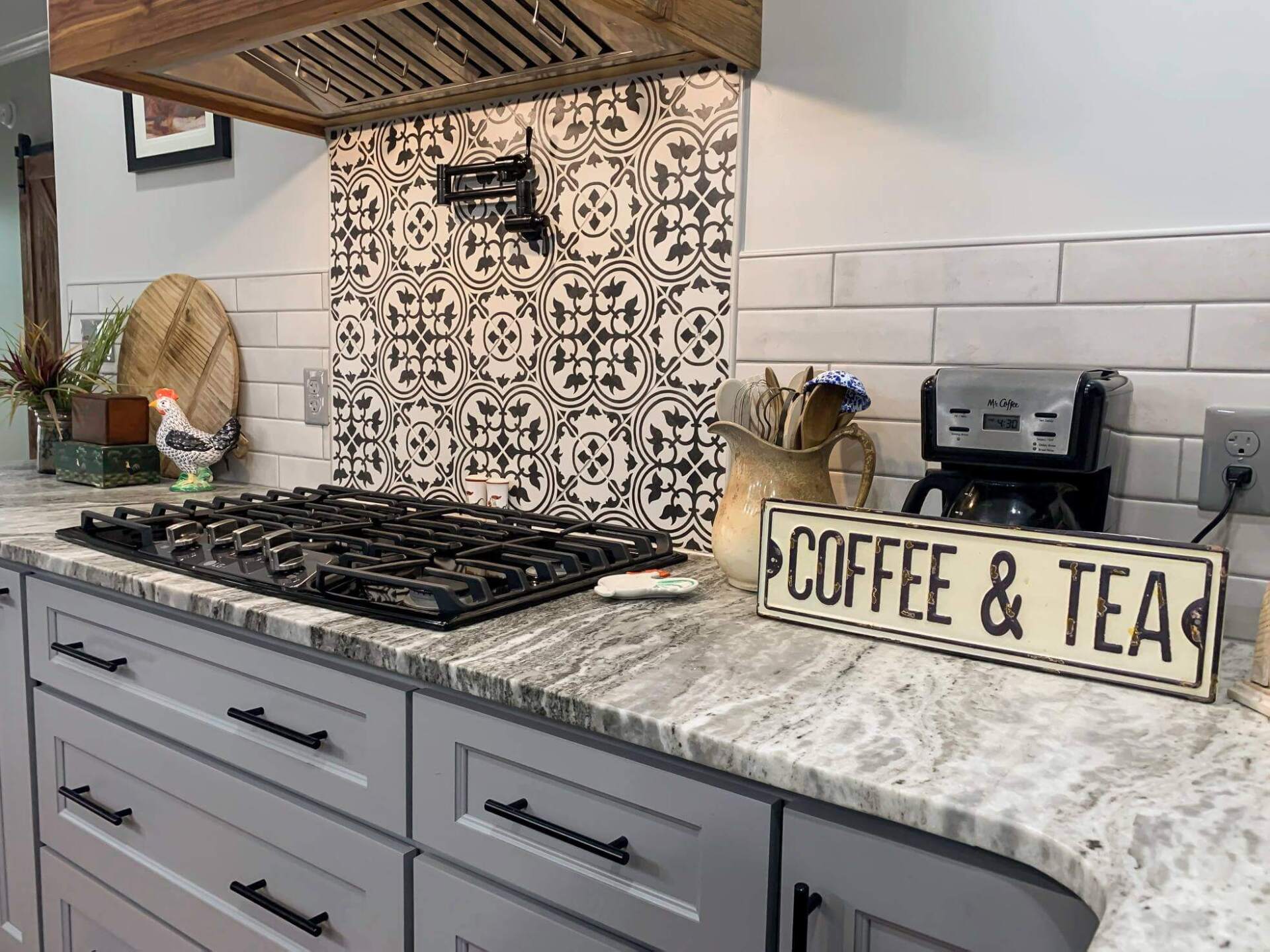 A kitchen with a sign that says `` coffee & tea '' on the counter.