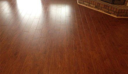 A living room with hardwood floors and a fireplace.