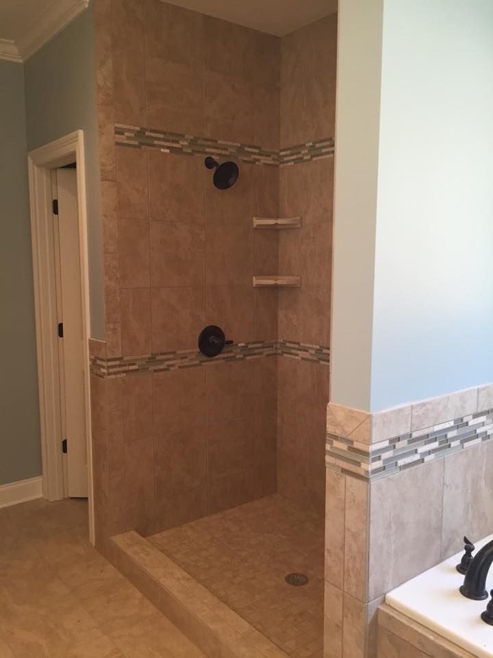 A bathroom with a walk in shower and a bathtub.