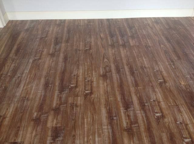 A close up of a wooden floor in a room.