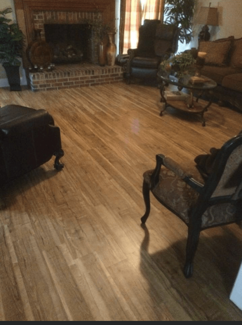 A living room with hardwood floors and a fireplace