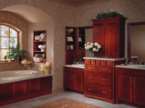 A bathroom with two sinks a tub and a window