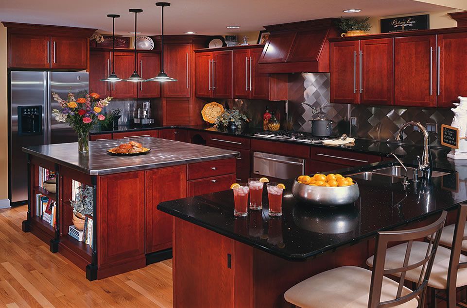 A kitchen with stainless steel appliances and wooden cabinets