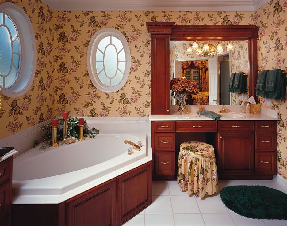 A bathroom with floral wallpaper and a round window