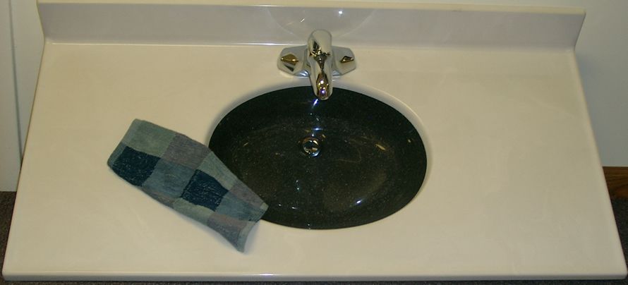 A bathroom sink with a blue towel on it