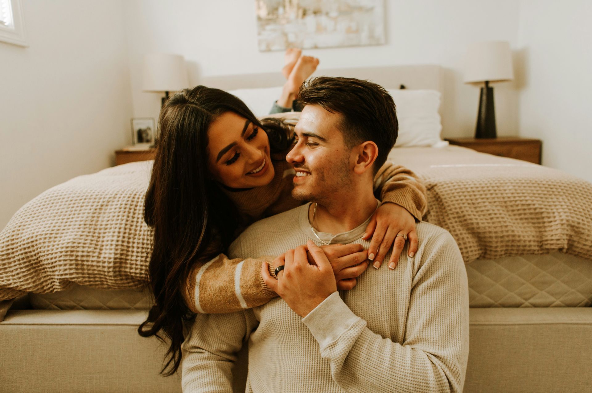 Couple smiling and embracing at home, symbolizing emotional connection and trust nurtured through Sacramento couples therapy.