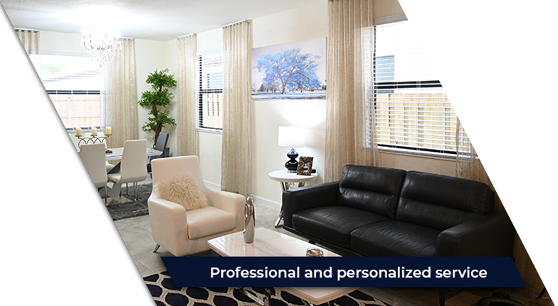 A living room with a black couch and a white chair.