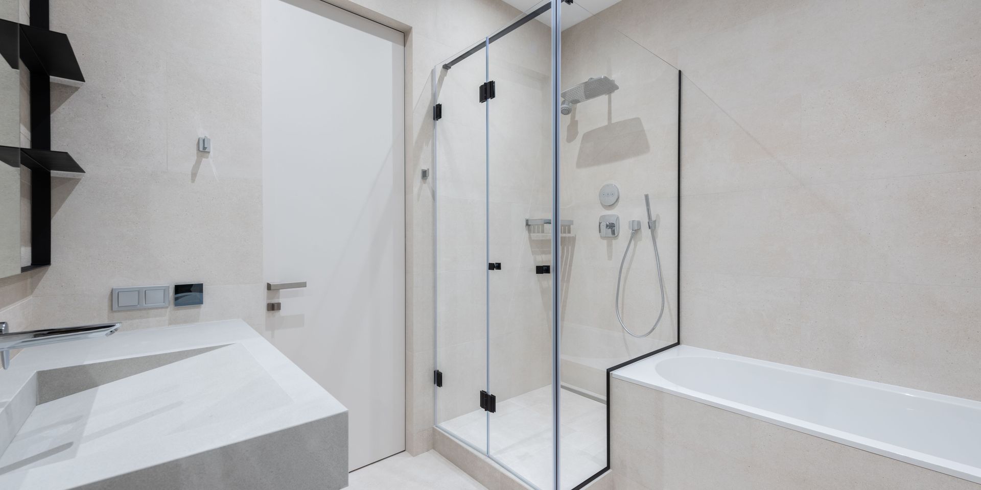 A bathroom with a walk in shower , sink and bathtub.