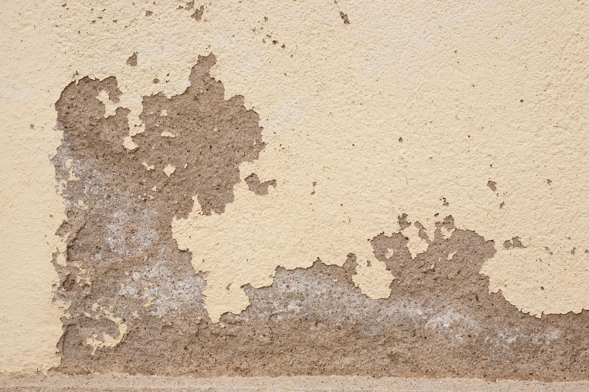 A close up of a wall with peeling paint