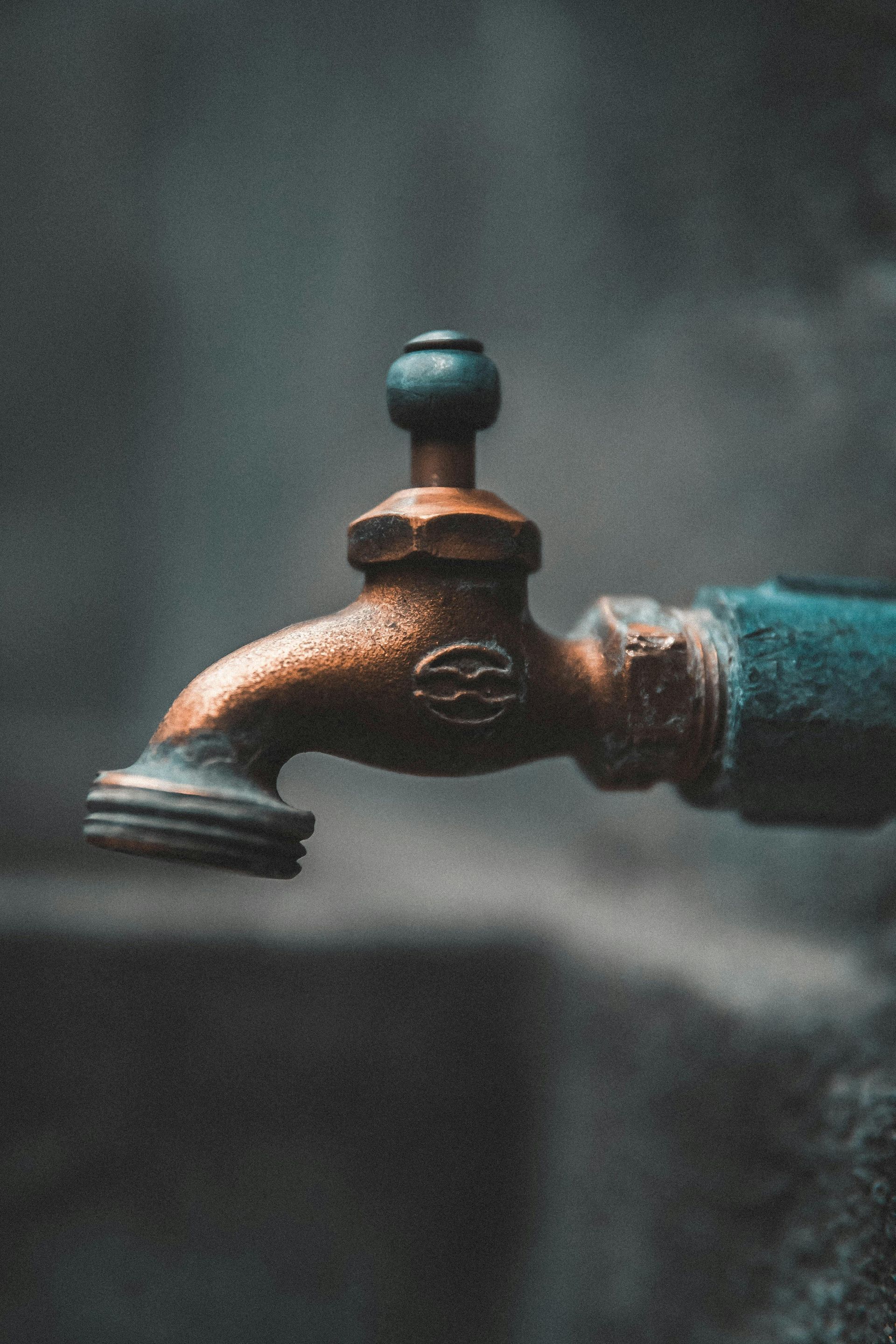 A close up of a faucet with water coming out of it.