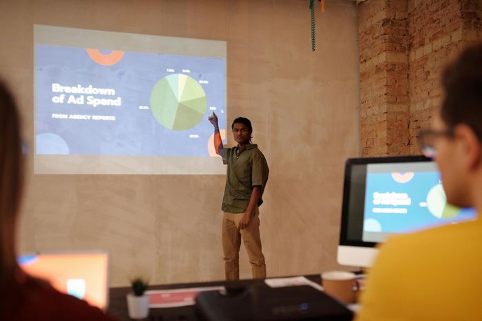 Photo of a person pointing to a graph