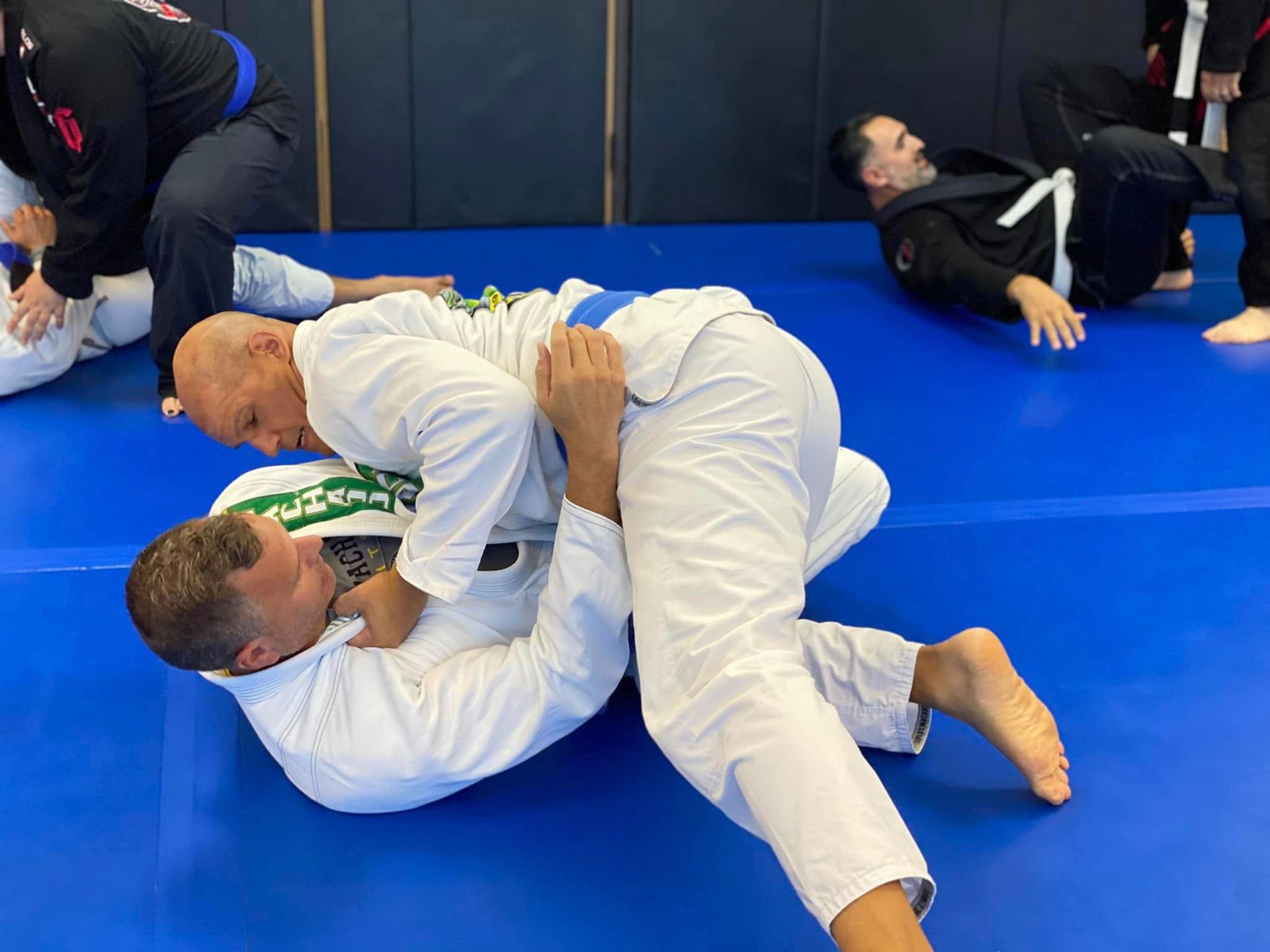 a man and a woman are practicing martial arts on a mat