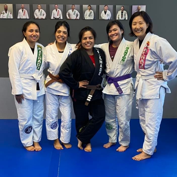 a group of women in karate uniforms pose for a picture