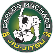 the logo for carlos machado jiu-jitsu shows two men wrestling