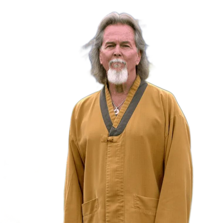 Man with long hair and beard in yellow robe, outdoors. Grandmaster Doug Fuechsel