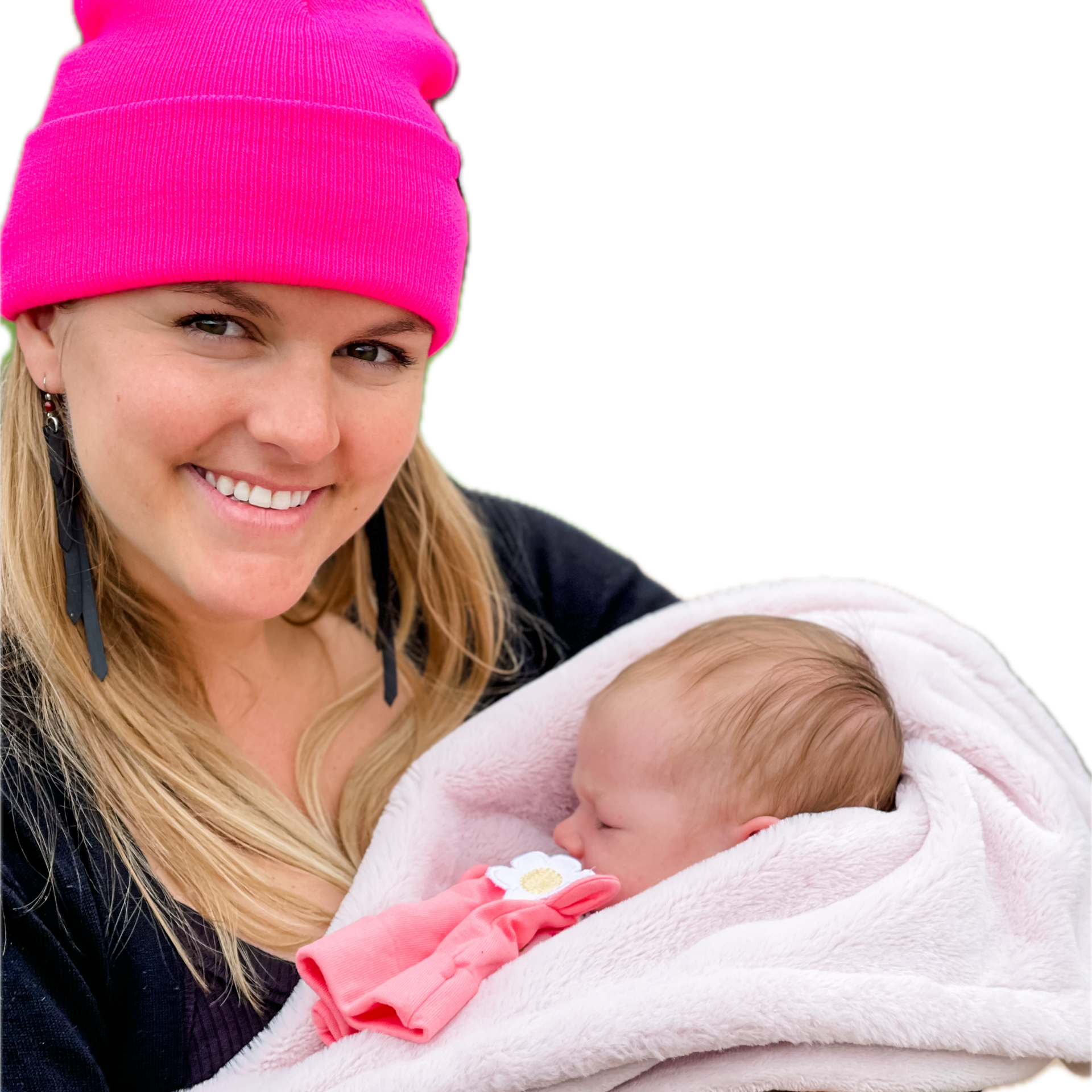 Woman in pink hat holding sleeping baby wrapped in pink blanket.